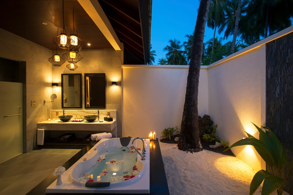 Candlelit bath with flower petals